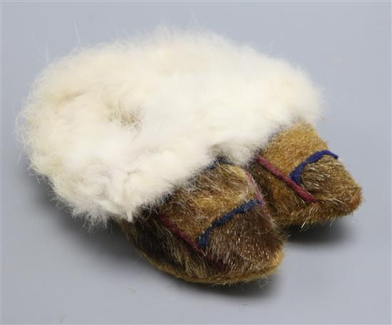 A pair of childs North American Indian seal skin and fur lined shoes/boots